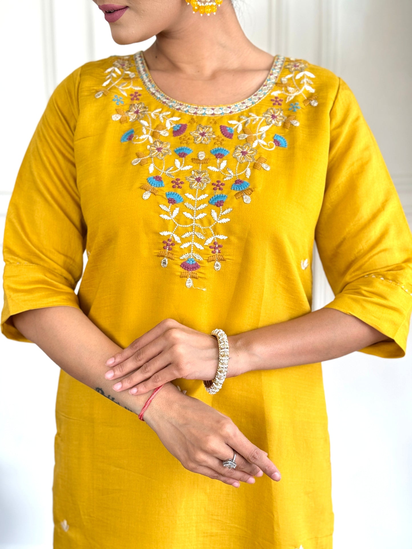 Brighten up your wardrobe with this radiant yellow kurti set, adorned with delicate floral embroidery and a sheer, printed dupatta