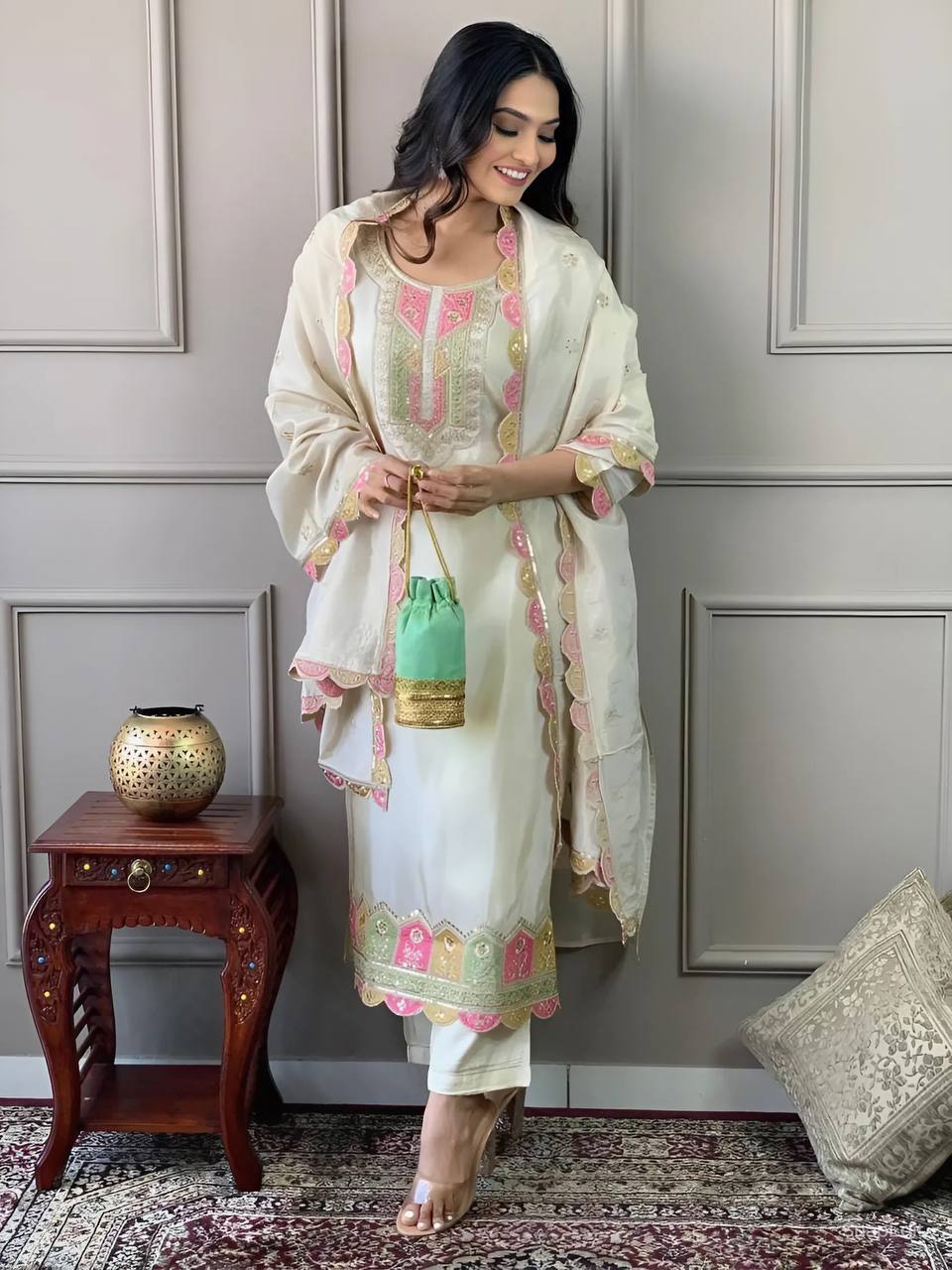 Elevate your elegance with this stunning off-white embroidered Kurti set. Adorned with delicate pink and gold accents, it features intricate detailing, a graceful dupatta