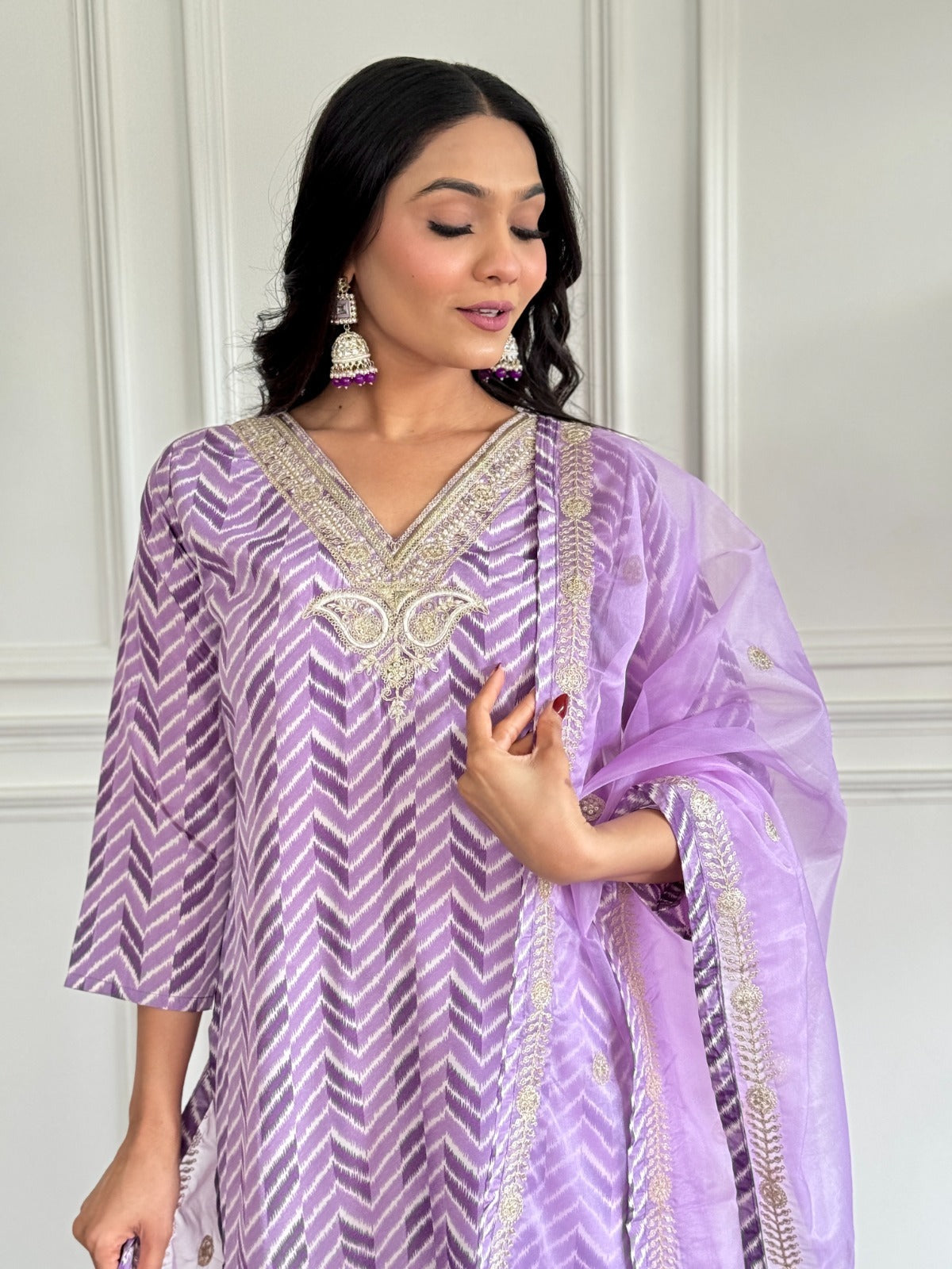 Step into elegance with this dreamy lavender kurti set, featuring intricate embroidery and a sheer, gold-accented dupatta