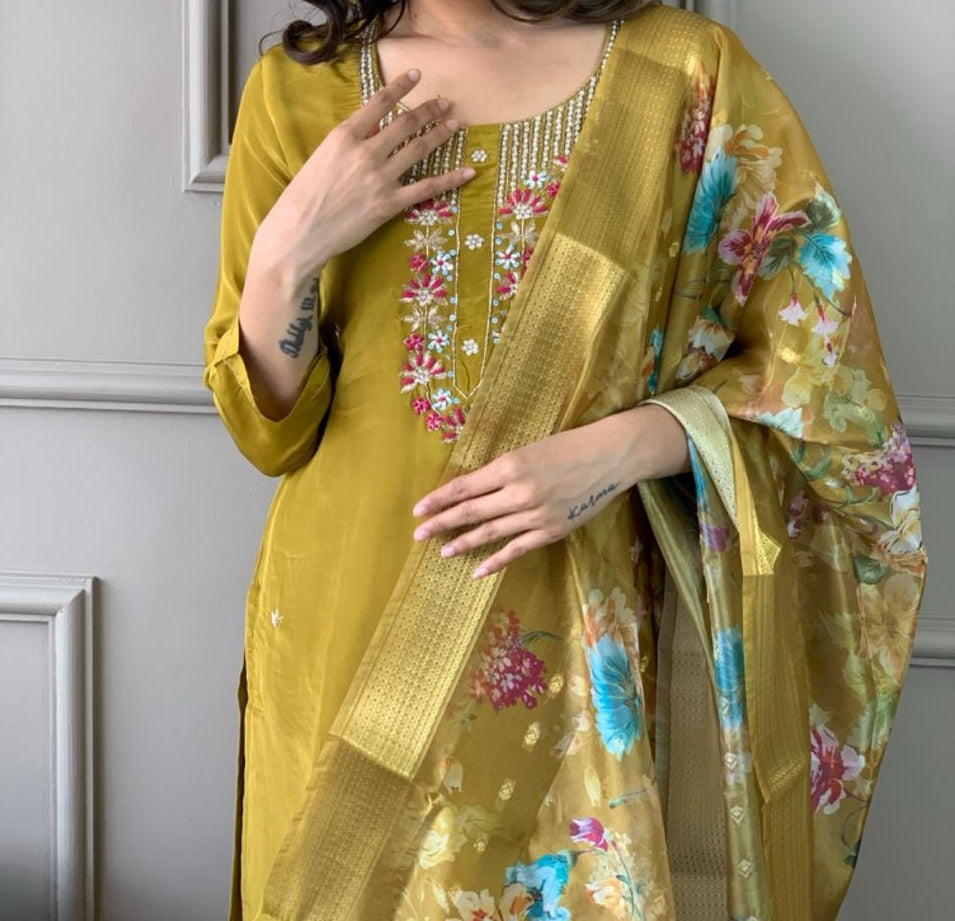 Elevate your style with this stunning mustard-yellow kurti set, featuring intricate floral embroidery and a delicate neckline design