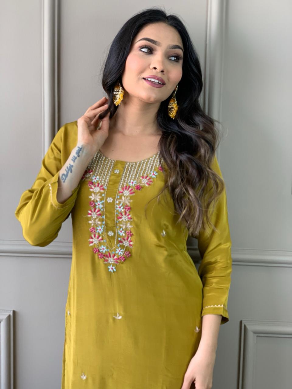 Elevate your style with this stunning mustard-yellow kurti set, featuring intricate floral embroidery and a delicate neckline design