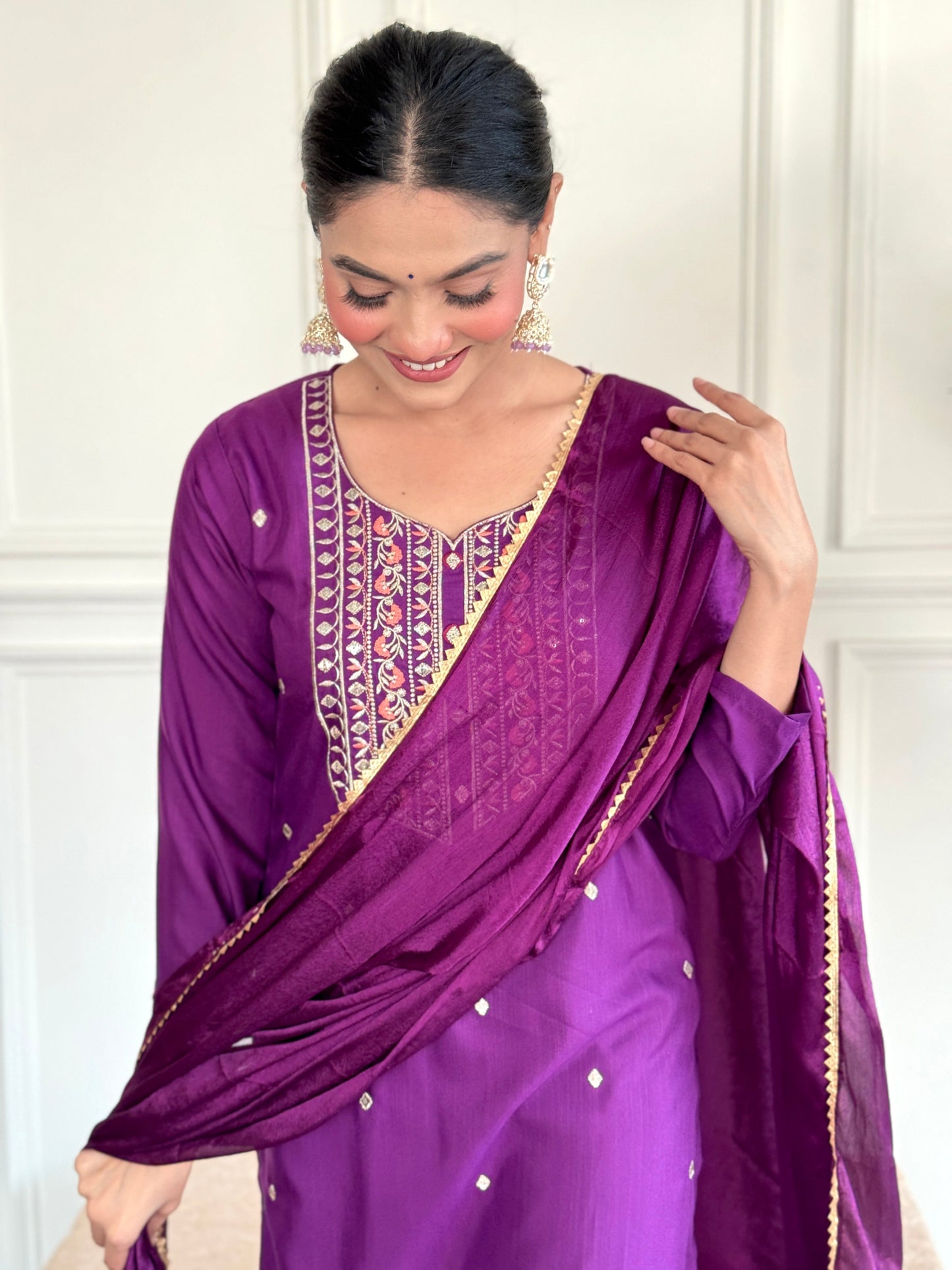 Elevate your style with this elegant purple Kurti set, featuring intricate embroidery and delicate embellishments