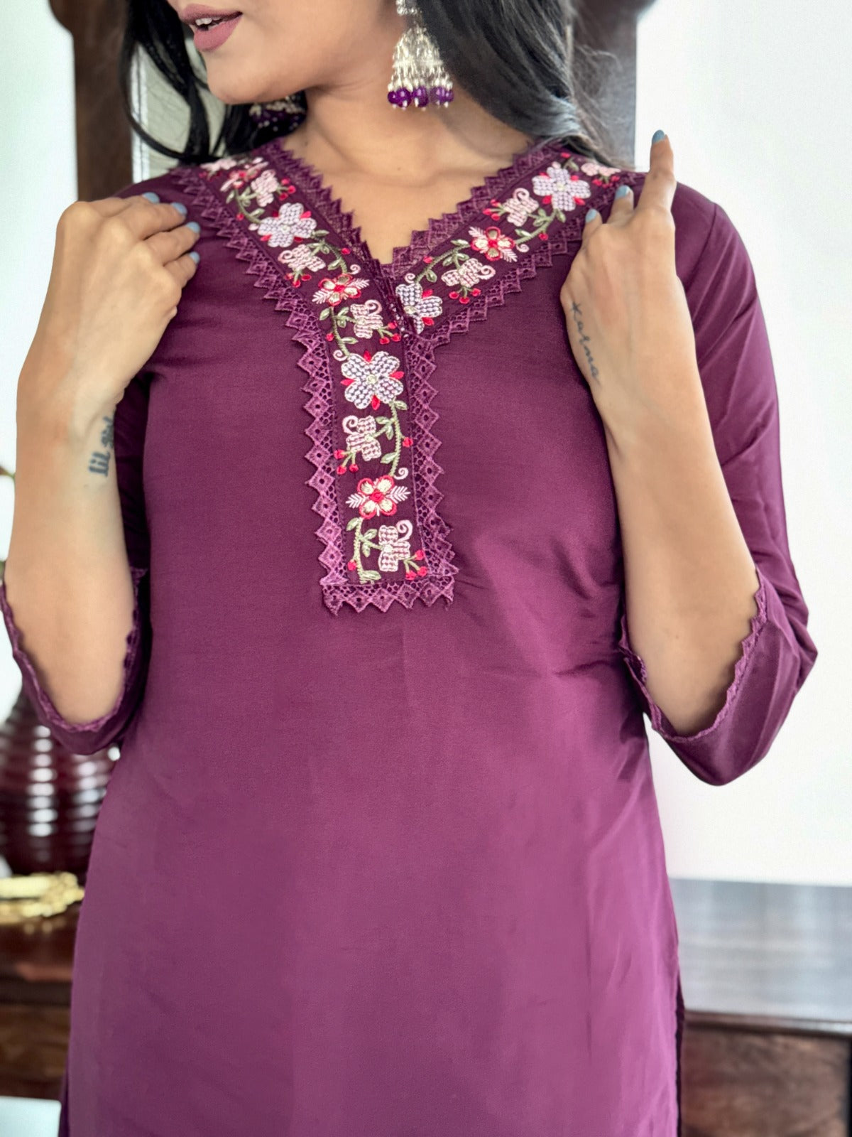 Embrace elegance with this rich plum kurti set, featuring intricate lace detailing and vibrant floral prints