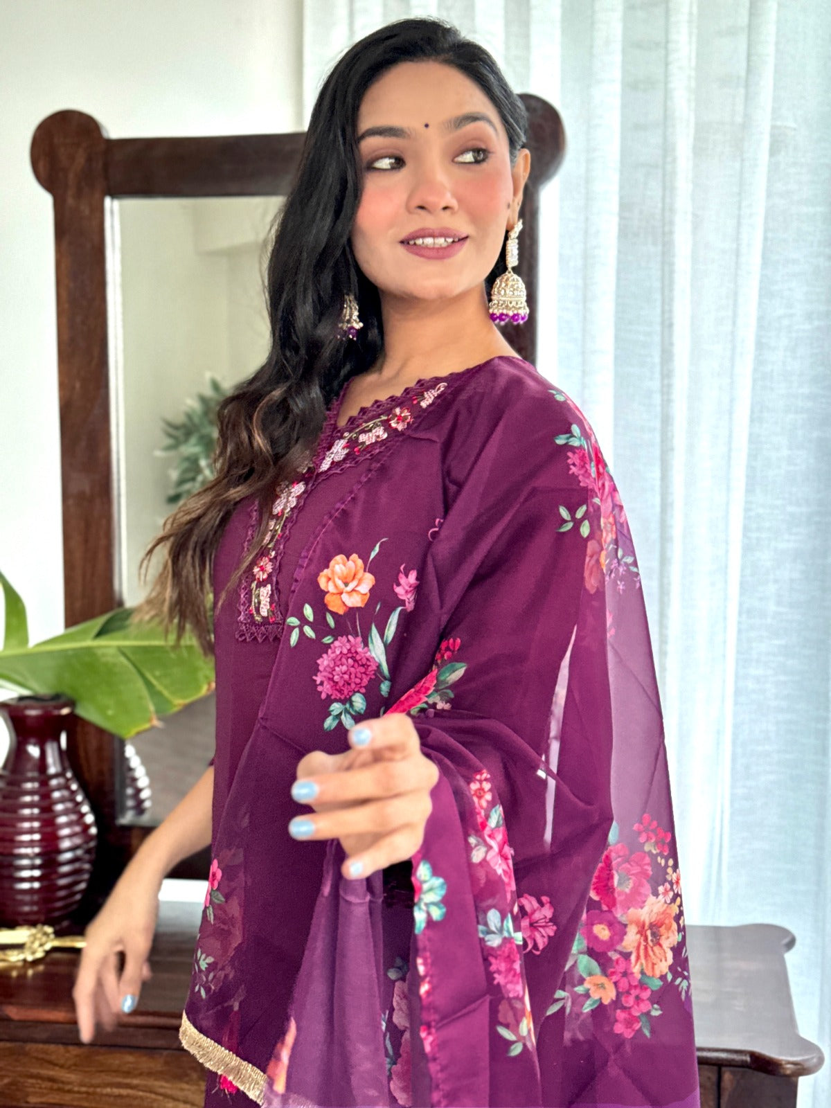 Embrace elegance with this rich plum kurti set, featuring intricate lace detailing and vibrant floral prints