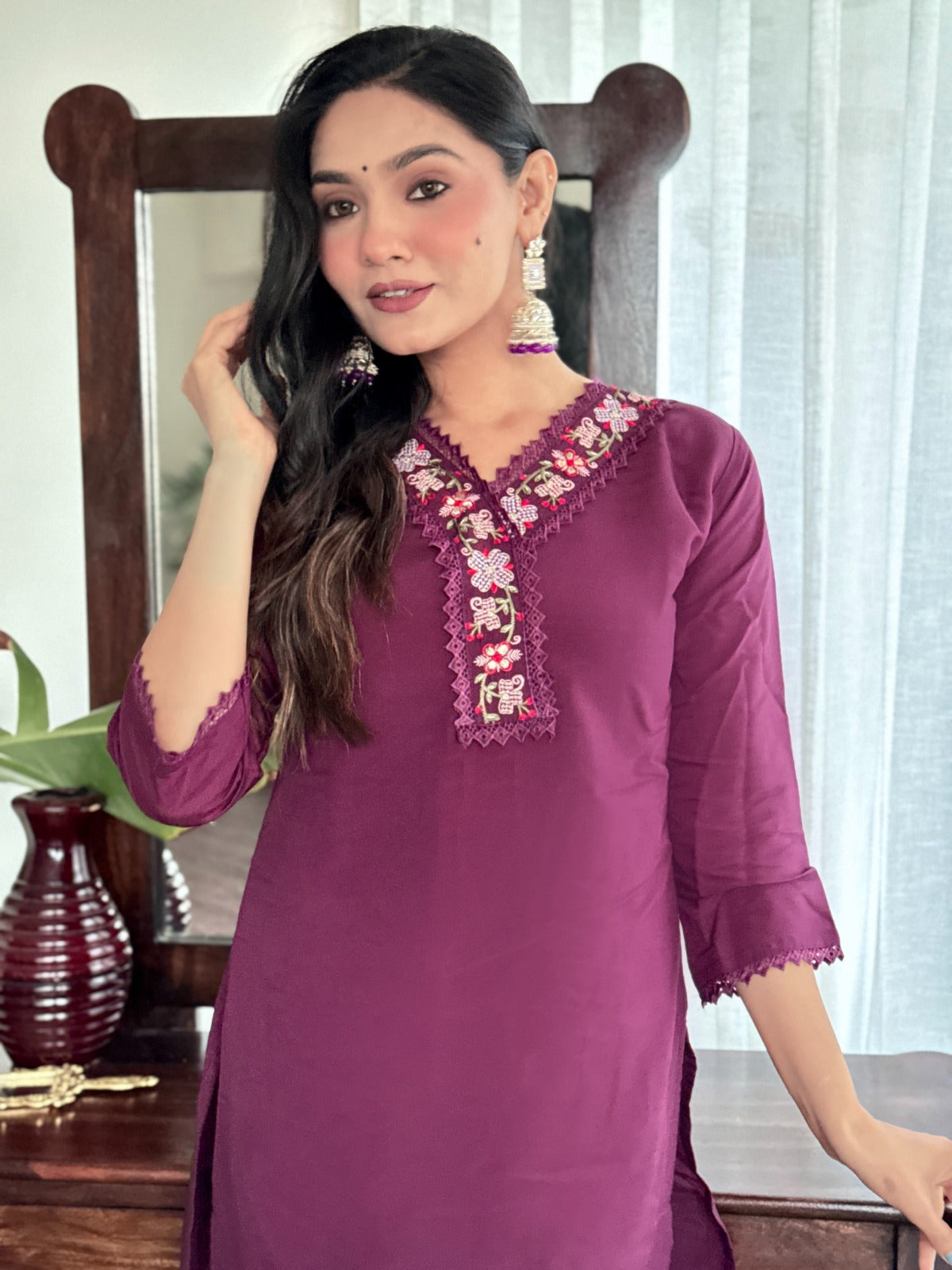 Embrace elegance with this rich plum kurti set, featuring intricate lace detailing and vibrant floral prints