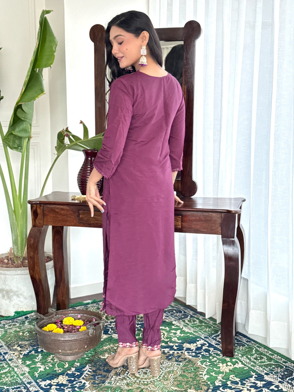 Embrace elegance with this rich plum kurti set, featuring intricate lace detailing and vibrant floral prints