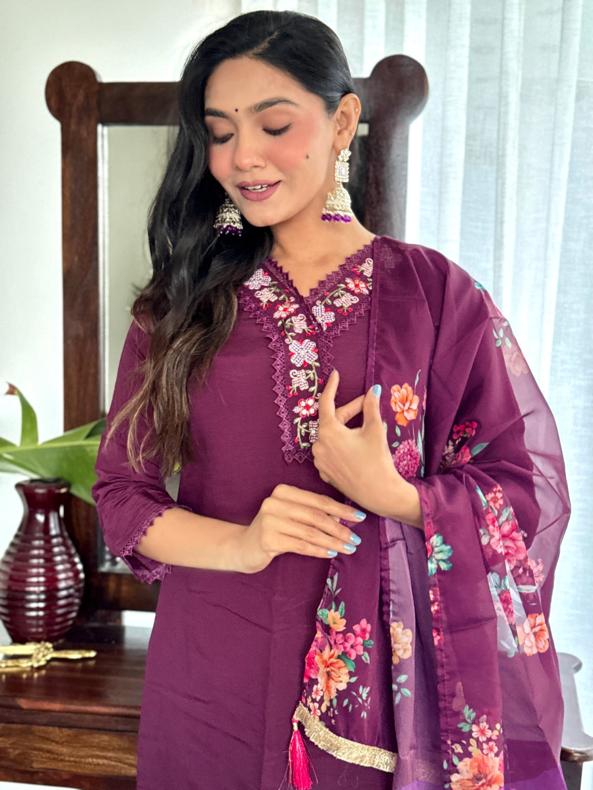 Embrace elegance with this rich plum kurti set, featuring intricate lace detailing and vibrant floral prints