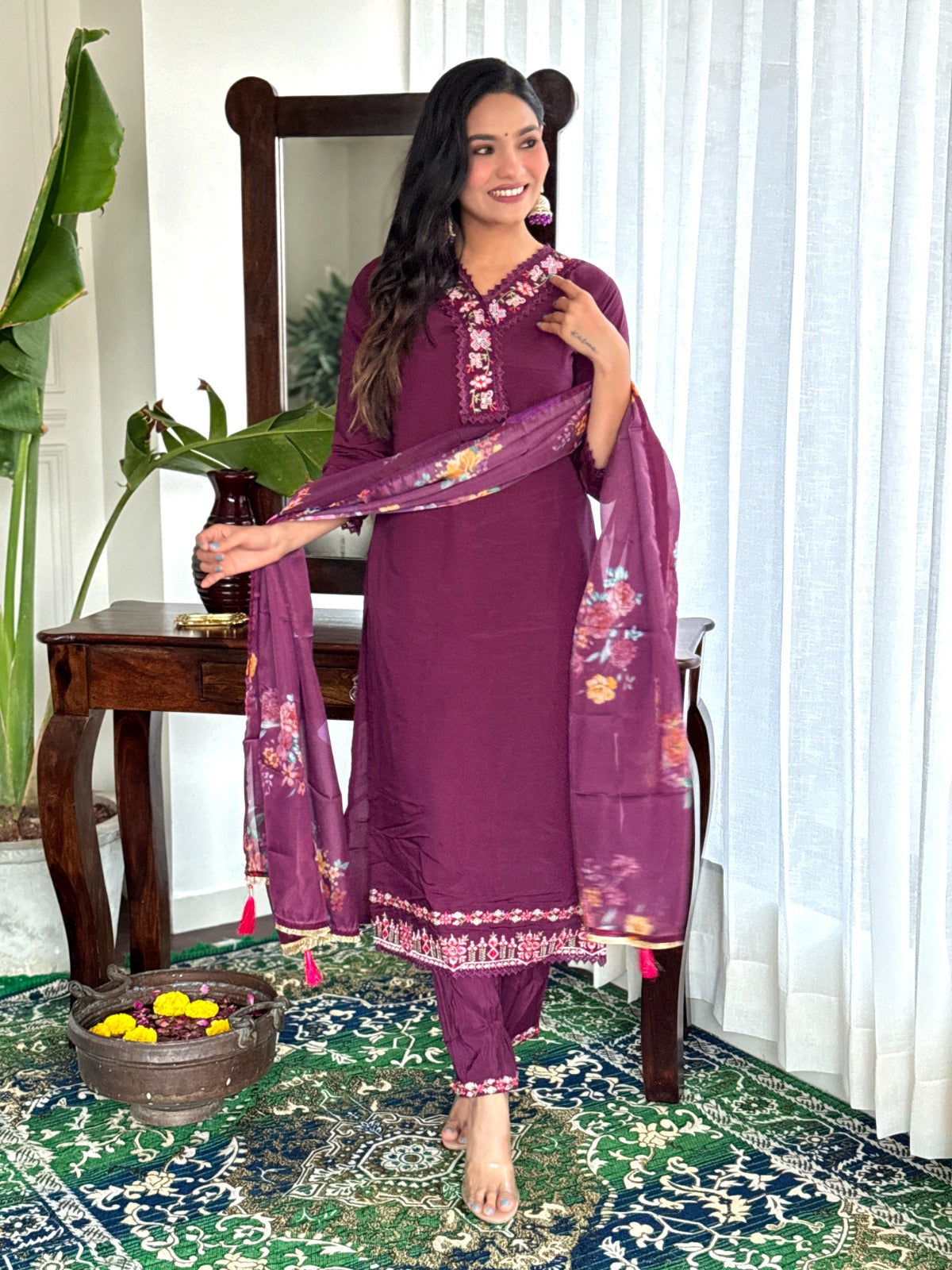 Embrace elegance with this rich plum kurti set, featuring intricate lace detailing and vibrant floral prints