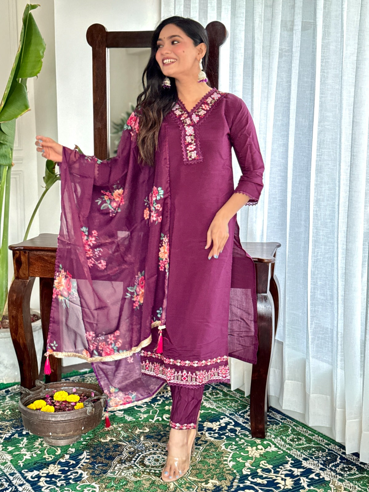 Embrace elegance with this rich plum kurti set, featuring intricate lace detailing and vibrant floral prints