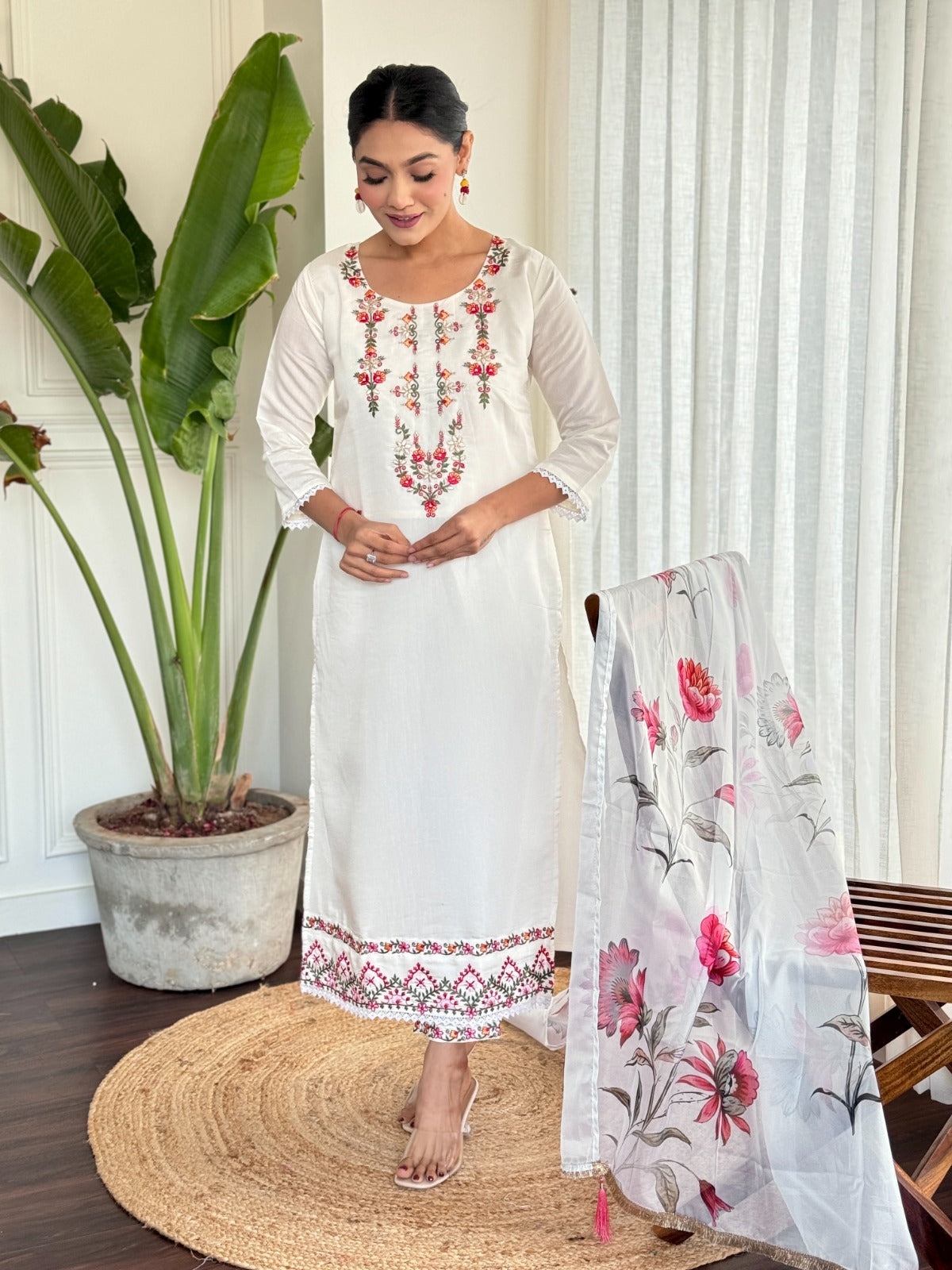 Step into elegance with this pristine white kurti set, beautifully adorned with delicate floral embroidery