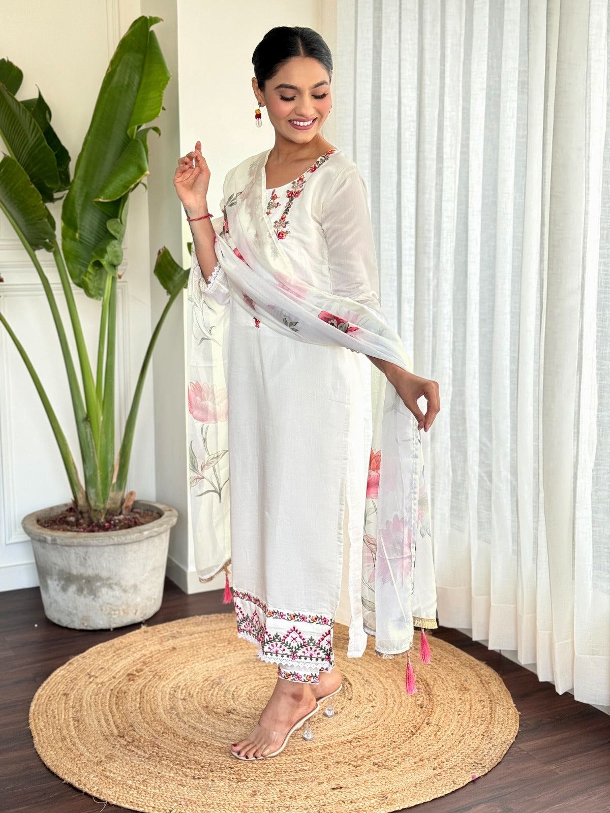Step into elegance with this pristine white kurti set, beautifully adorned with delicate floral embroidery