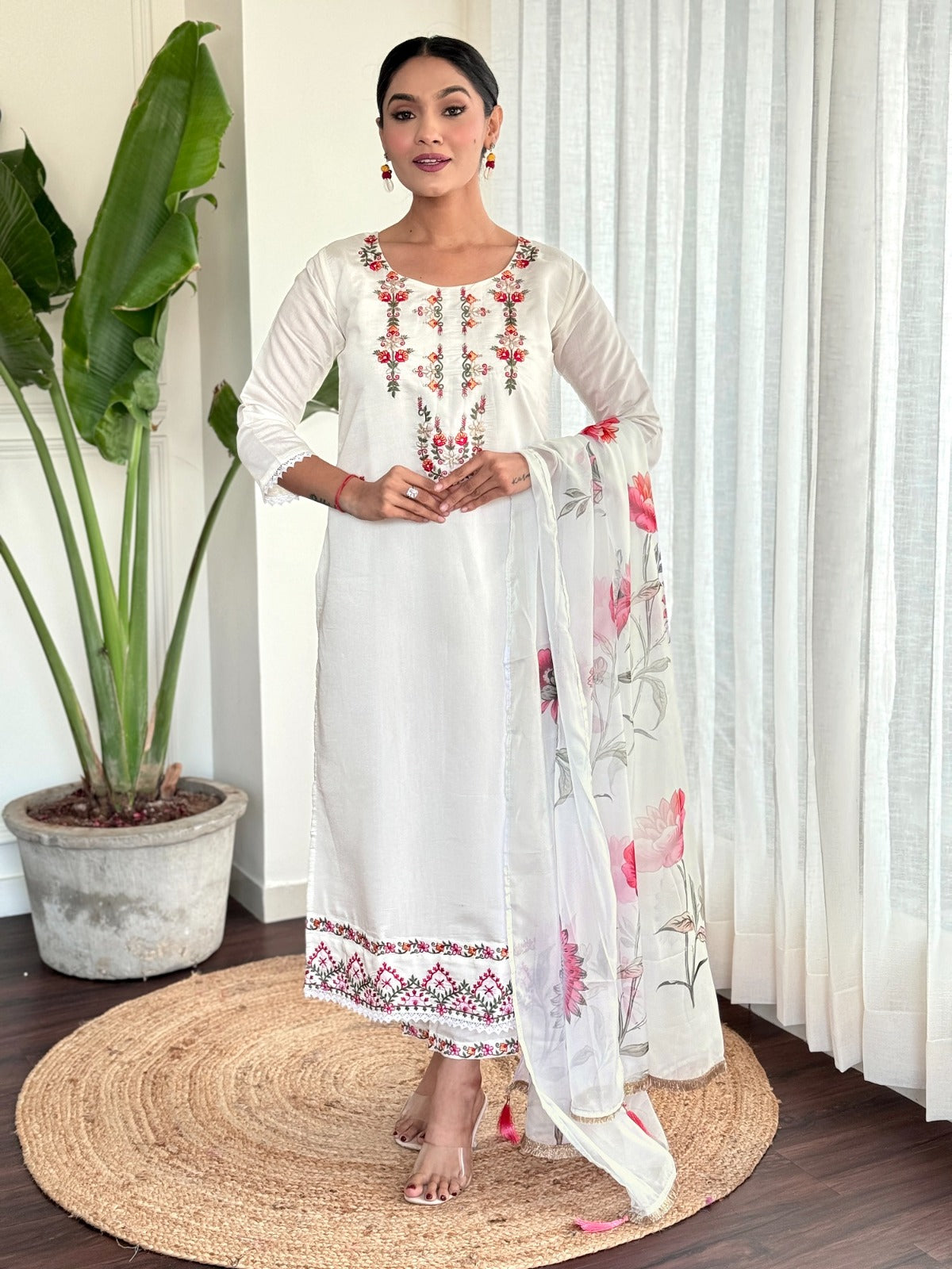 Step into elegance with this pristine white kurti set, beautifully adorned with delicate floral embroidery