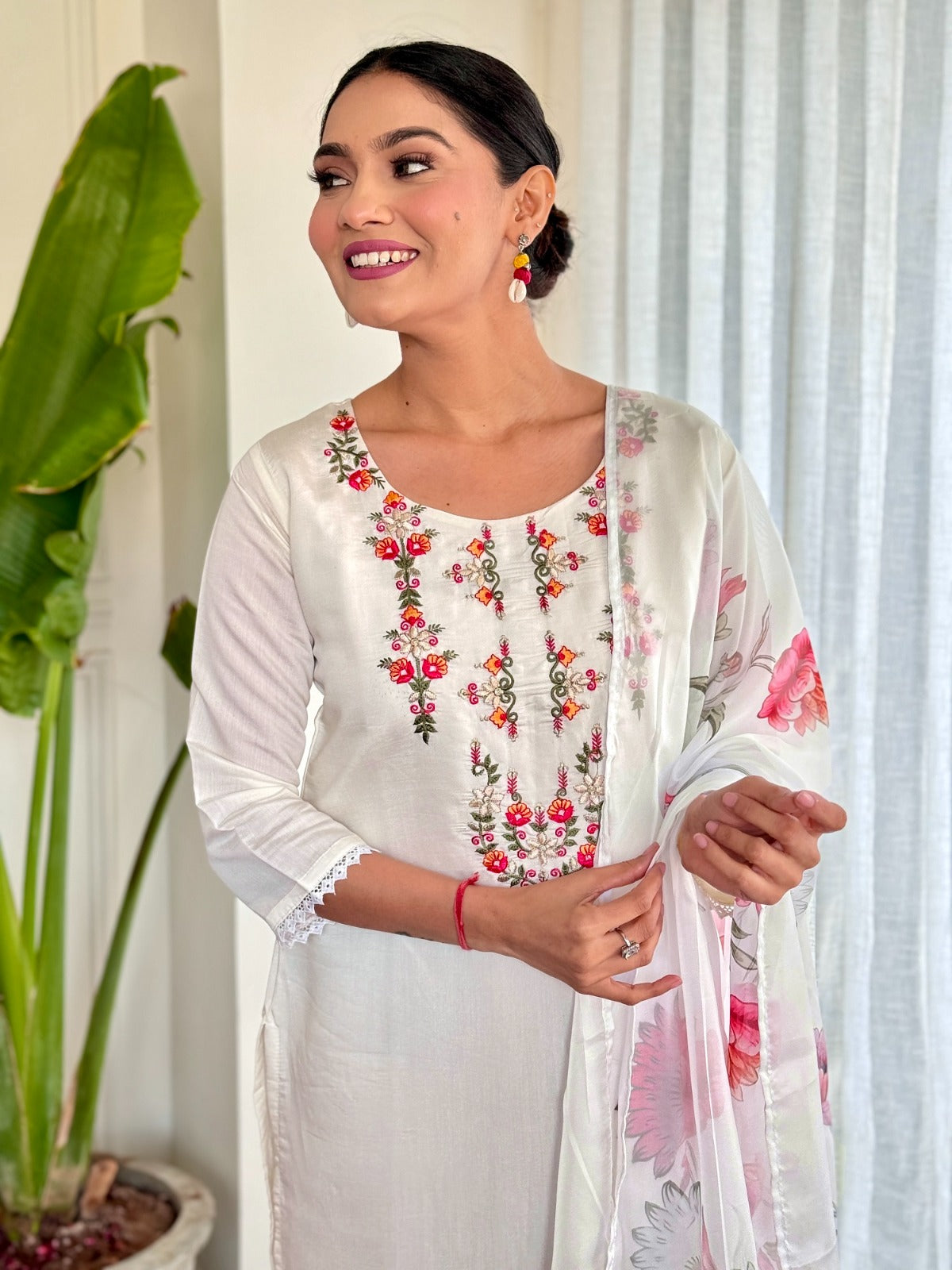 Step into elegance with this pristine white kurti set, beautifully adorned with delicate floral embroidery