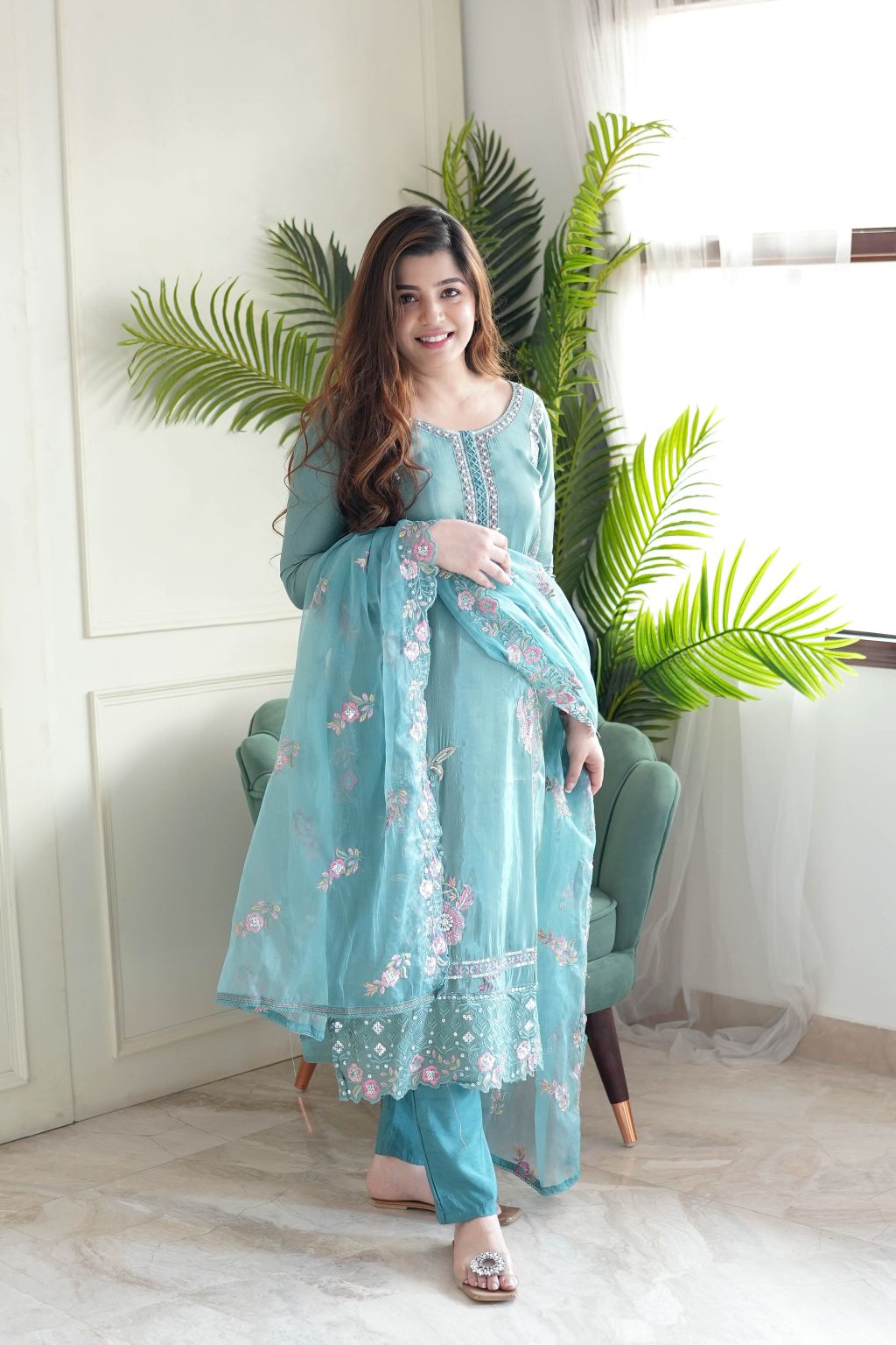 This stunning aqua blue kurti set is crafted with intricate floral embroidery, delicate embellishments, and a sheer dupatta for an elegant finish