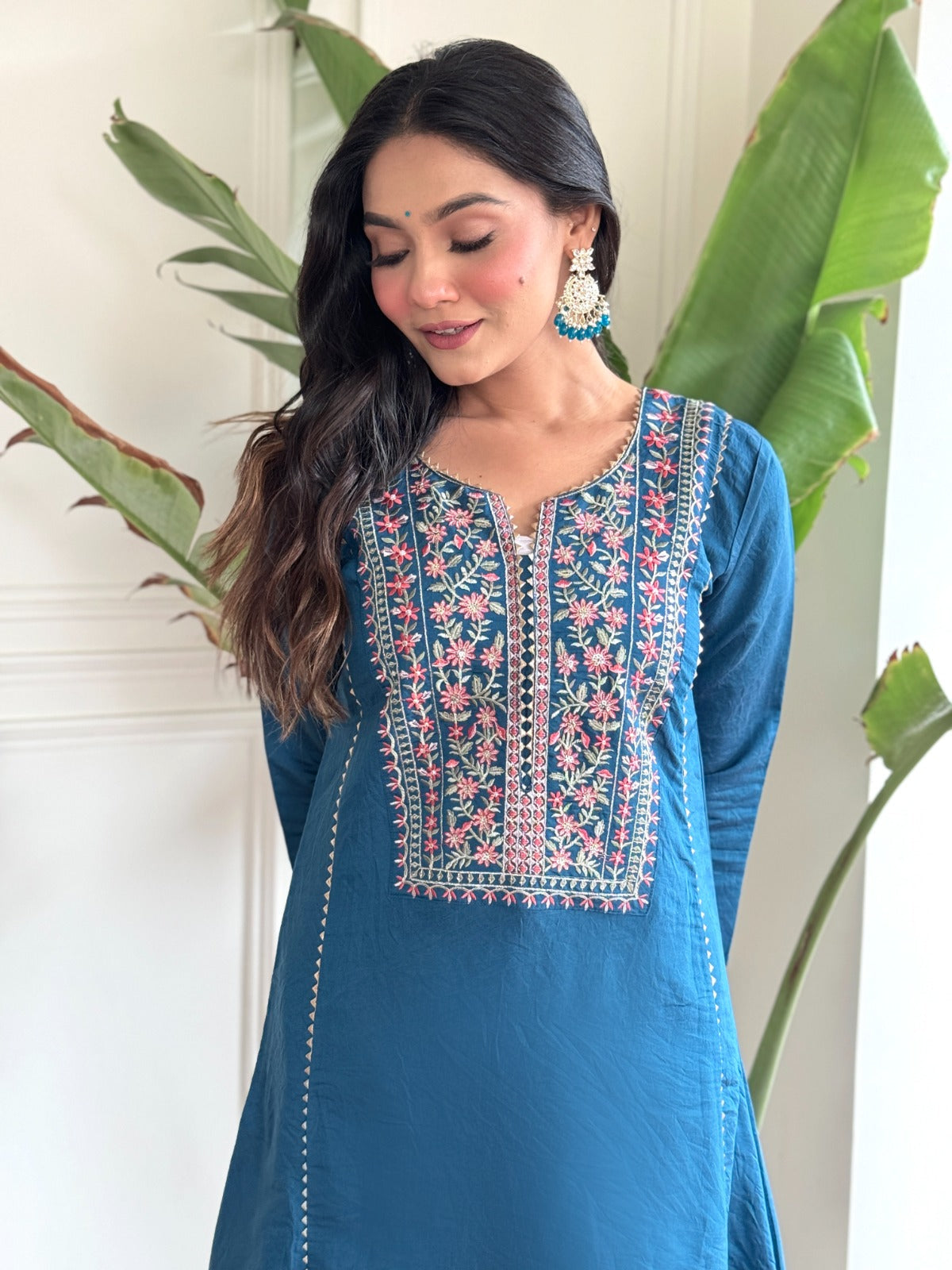 "Make a statement in this gorgeous teal blue kurti set, adorned with intricate embroidery and delicate detailing