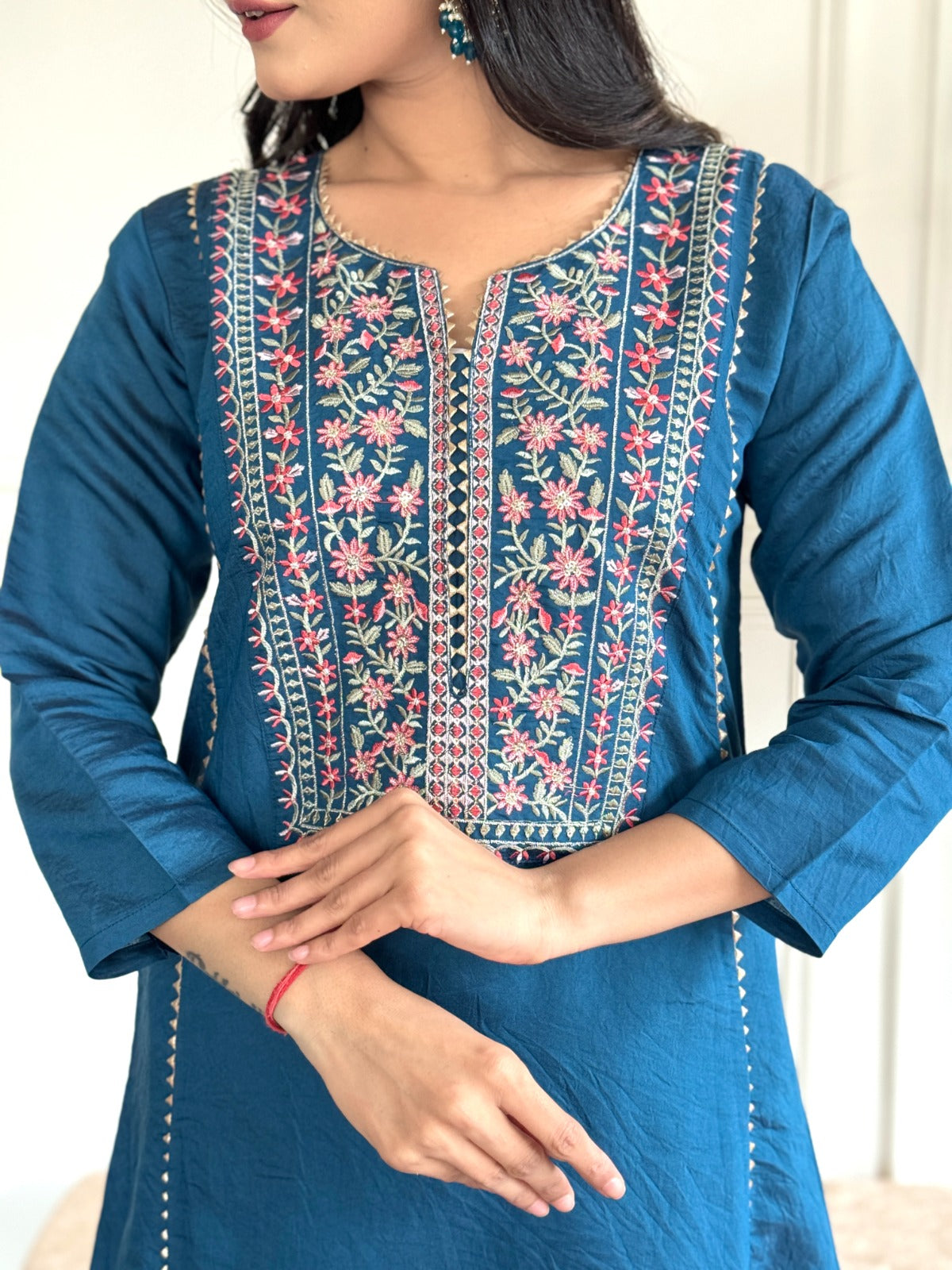"Make a statement in this gorgeous teal blue kurti set, adorned with intricate embroidery and delicate detailing