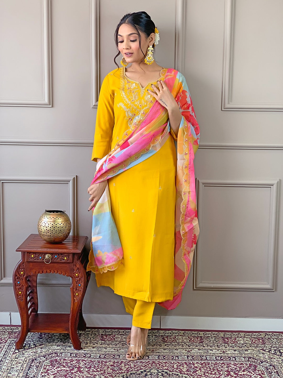 Brighten up your wardrobe with this radiant yellow kurti set, featuring delicate embroidery and a vibrant multicolored dupatta