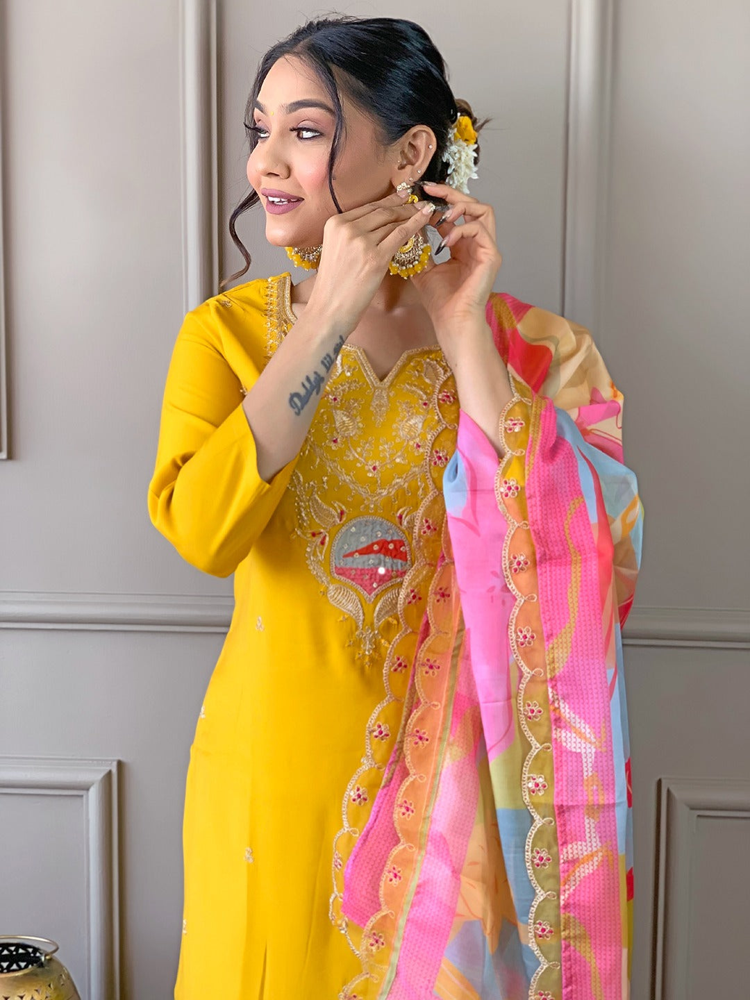 Brighten up your wardrobe with this radiant yellow kurti set, featuring delicate embroidery and a vibrant multicolored dupatta