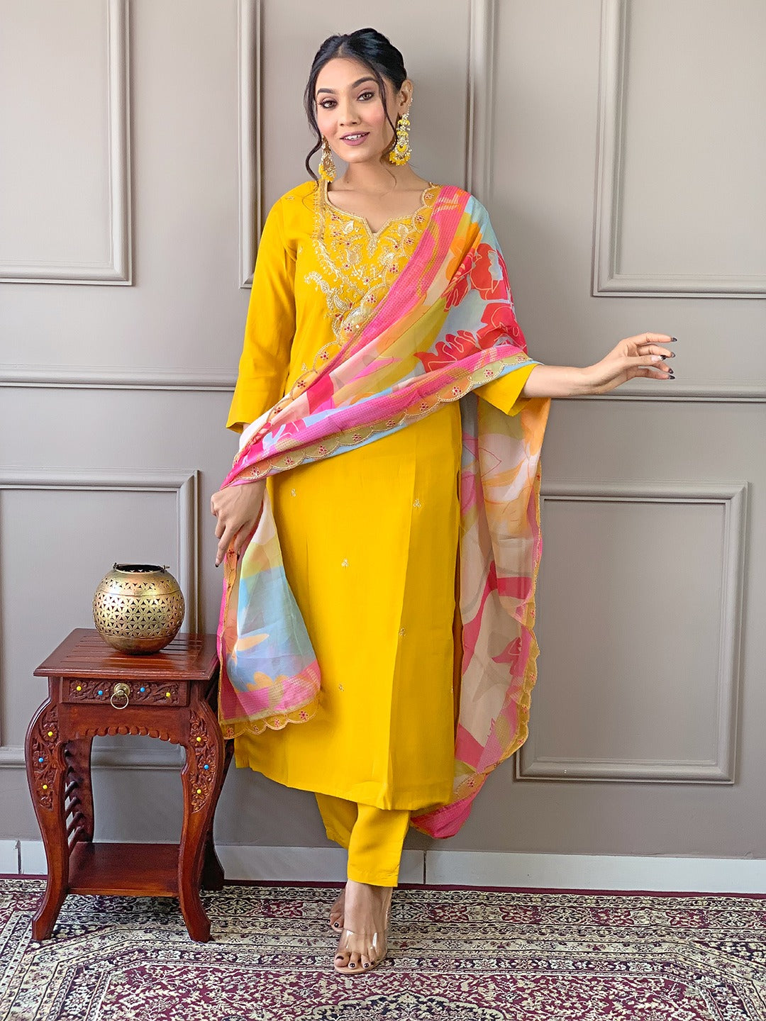 Brighten up your wardrobe with this radiant yellow kurti set, featuring delicate embroidery and a vibrant multicolored dupatta