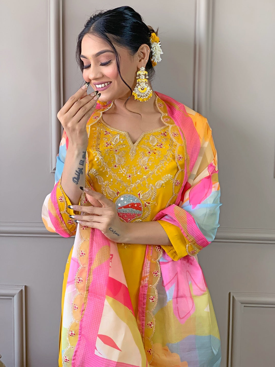 Brighten up your wardrobe with this radiant yellow kurti set, featuring delicate embroidery and a vibrant multicolored dupatta