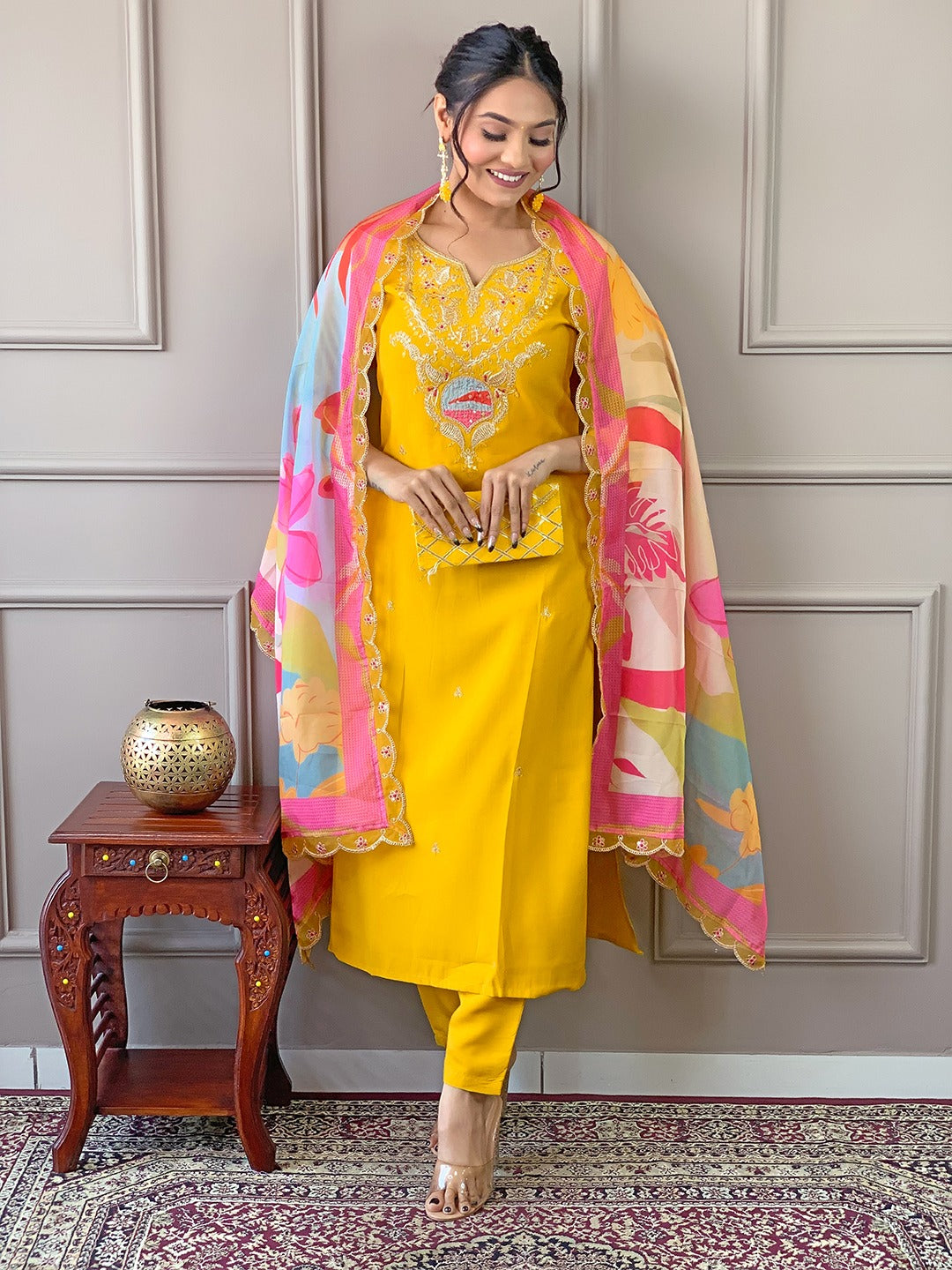 Brighten up your wardrobe with this radiant yellow kurti set, featuring delicate embroidery and a vibrant multicolored dupatta