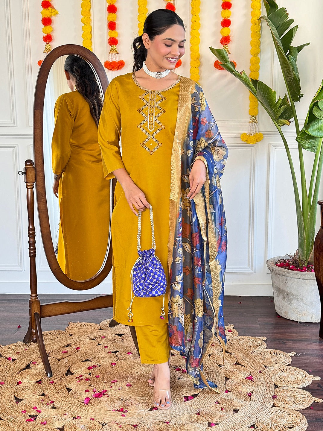Embrace timeless elegance with this mustard yellow kurti set, featuring delicate embroidery and a regal blue floral dupatta