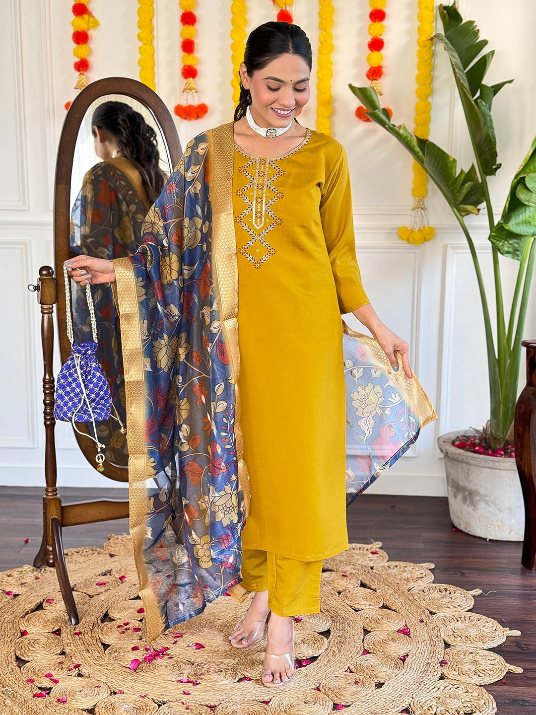 Embrace timeless elegance with this mustard yellow kurti set, featuring delicate embroidery and a regal blue floral dupatta