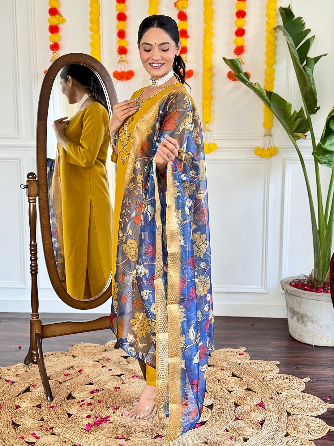 Embrace timeless elegance with this mustard yellow kurti set, featuring delicate embroidery and a regal blue floral dupatta