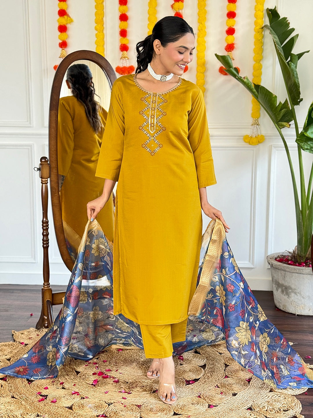Embrace timeless elegance with this mustard yellow kurti set, featuring delicate embroidery and a regal blue floral dupatta