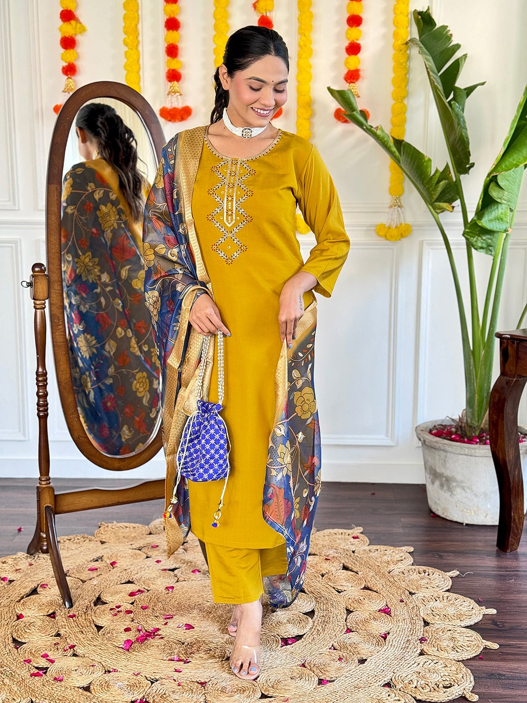 Embrace timeless elegance with this mustard yellow kurti set, featuring delicate embroidery and a regal blue floral dupatta