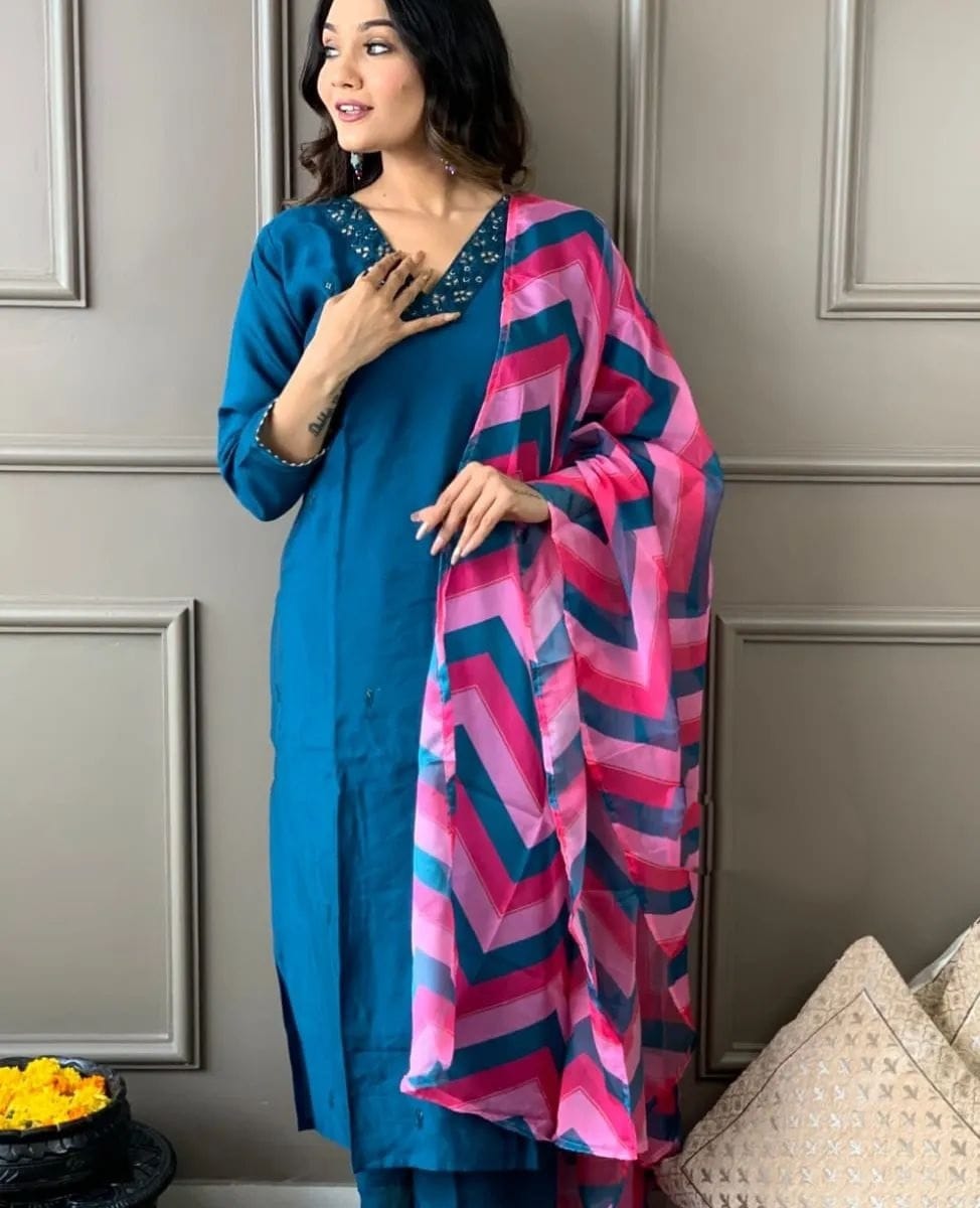 Elevate your style with this elegant blue kurti set, featuring intricate embellishments and a vibrant pink and blue zigzag dupatta