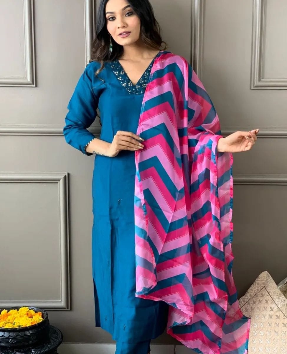 Elevate your style with this elegant blue kurti set, featuring intricate embellishments and a vibrant pink and blue zigzag dupatta
