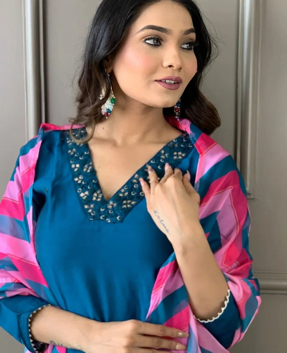 Elevate your style with this elegant blue kurti set, featuring intricate embellishments and a vibrant pink and blue zigzag dupatta