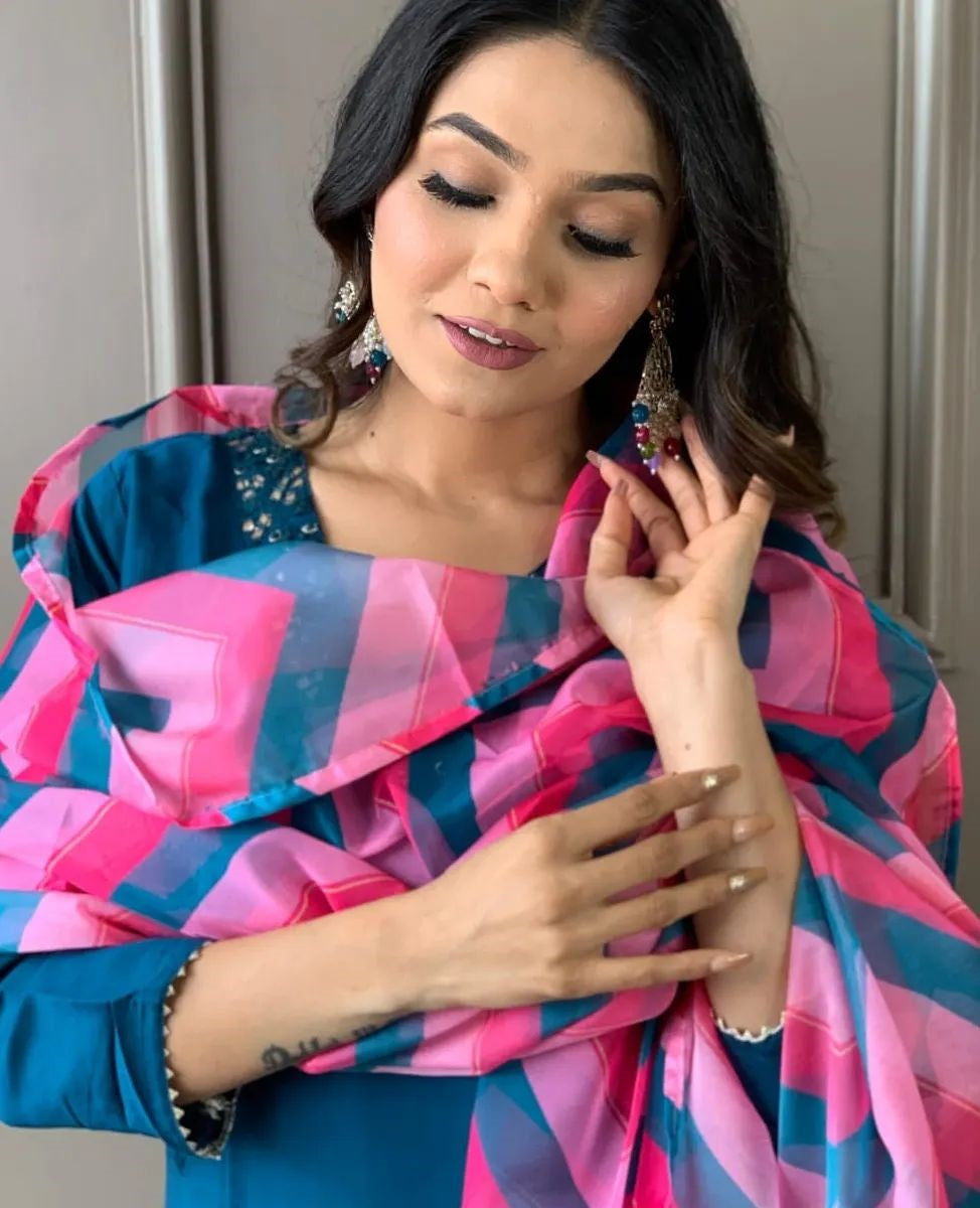 Elevate your style with this elegant blue kurti set, featuring intricate embellishments and a vibrant pink and blue zigzag dupatta