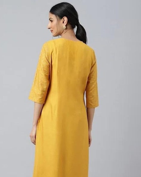 Embrace festive flair with this radiant mustard kurta set featuring delicate embroidery and a striking teal dupatta