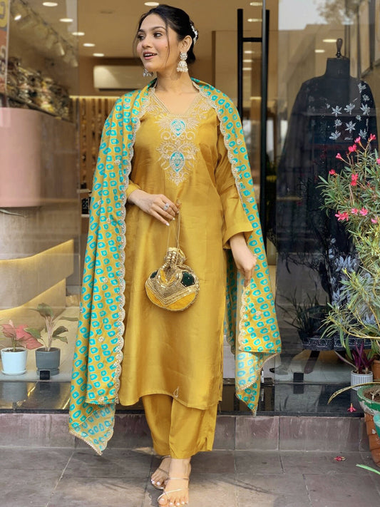 Embrace festive flair with this radiant mustard kurta set featuring delicate embroidery and a striking teal dupatta