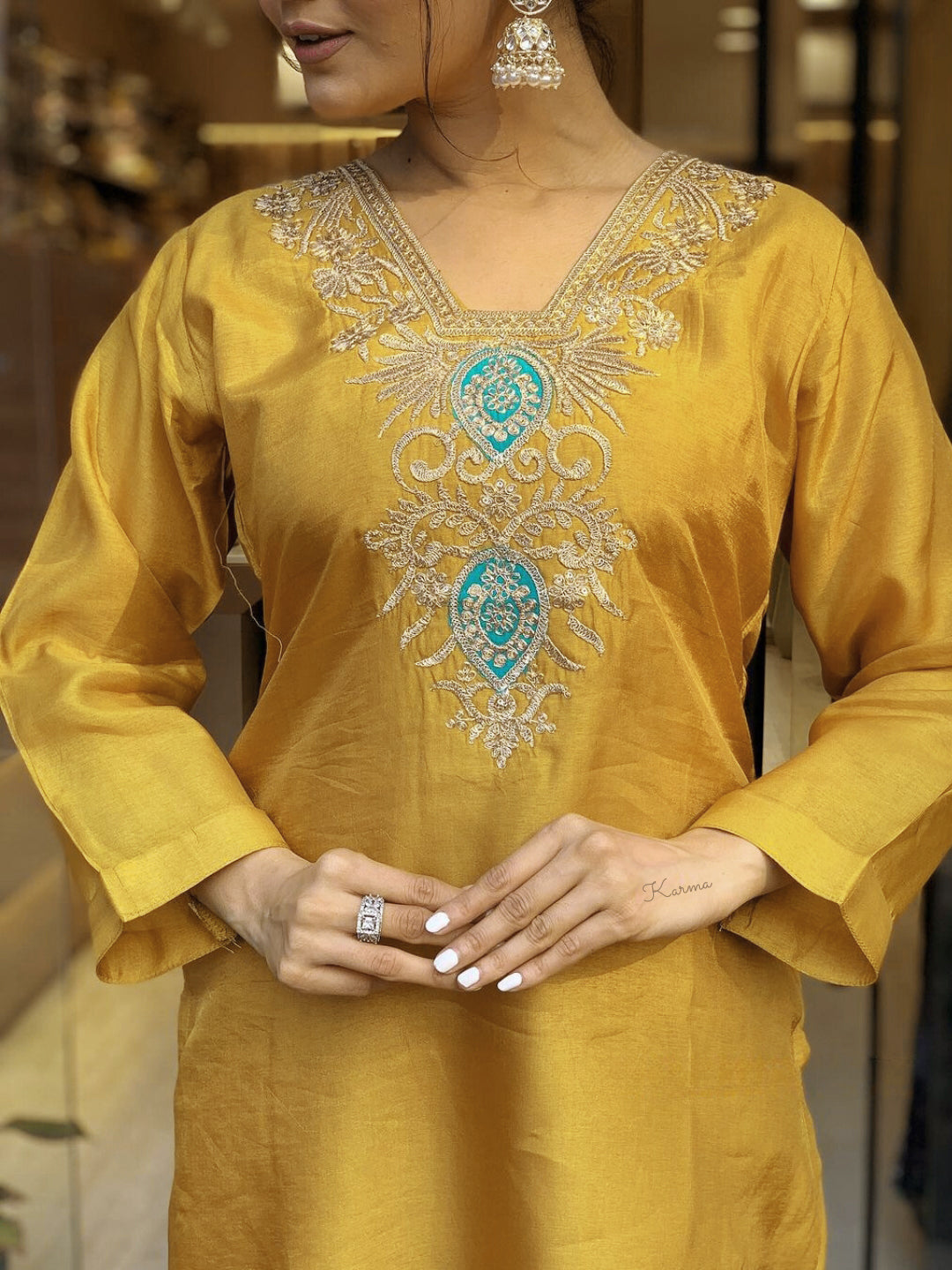 Embrace festive flair with this radiant mustard kurta set featuring delicate embroidery and a striking teal dupatta