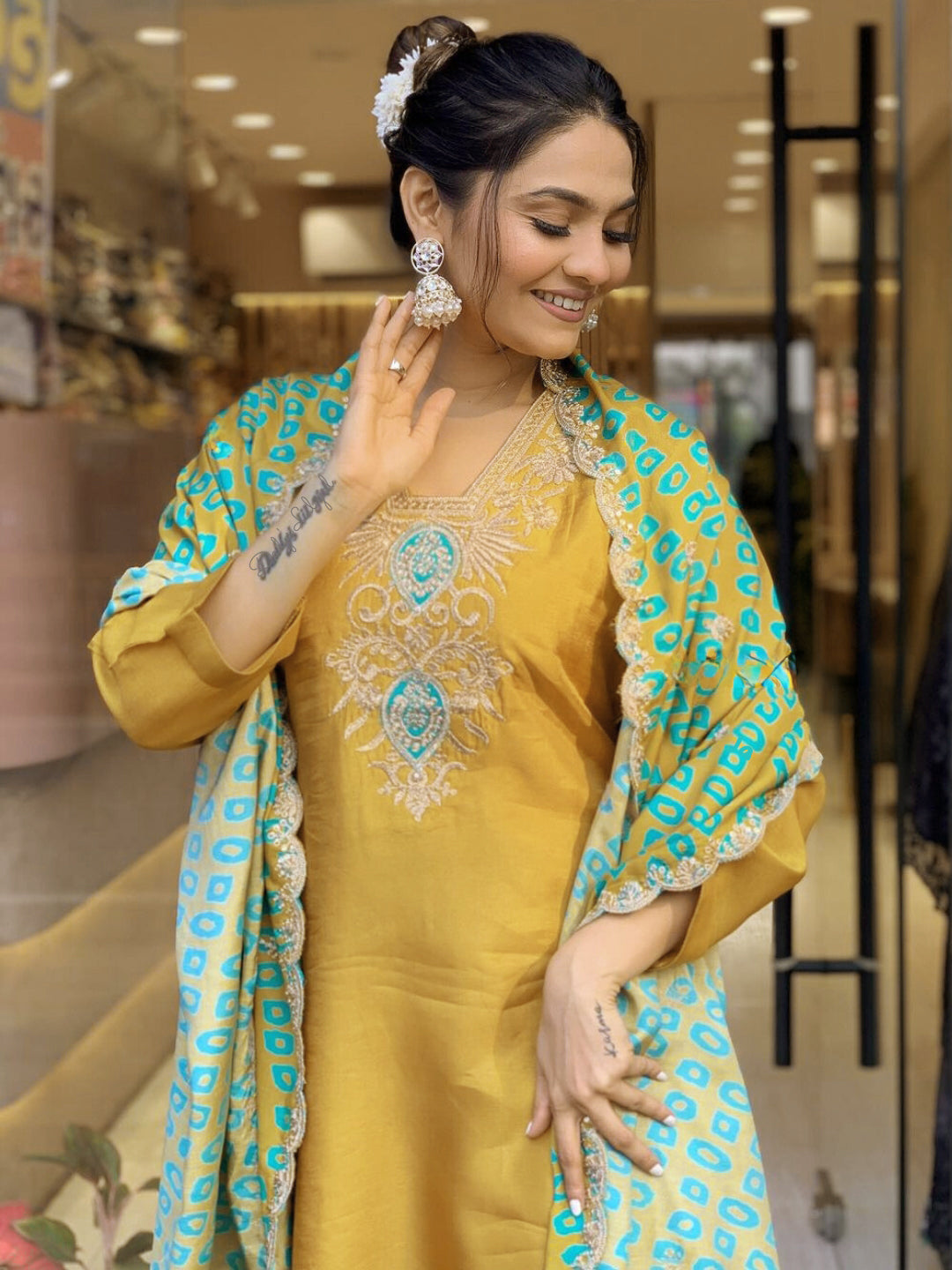 Embrace festive flair with this radiant mustard kurta set featuring delicate embroidery and a striking teal dupatta