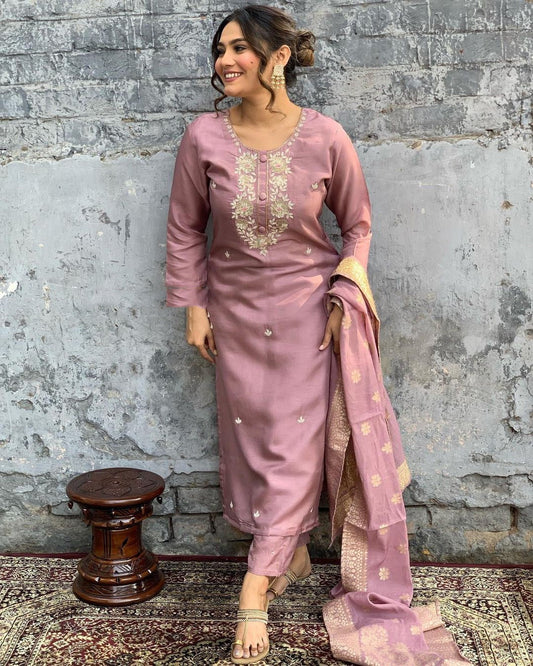 Indulge in sophistication with this subtle mauve kurta set, intricately adorned with gold-toned embroidery