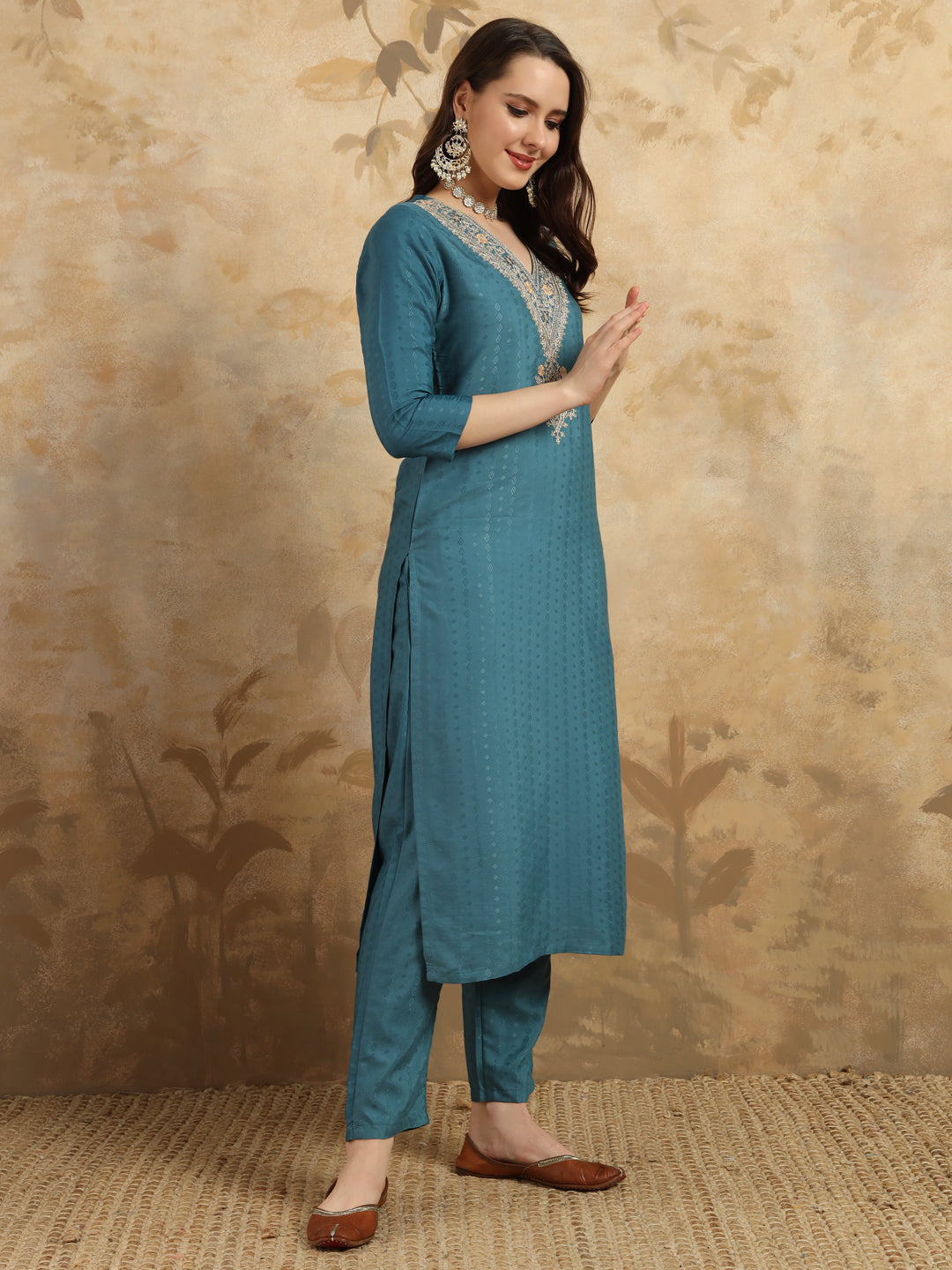 Infuse your wardrobe with elegance in this teal kurta set, showcasing delicate embroidery and a romantic floral dupatta