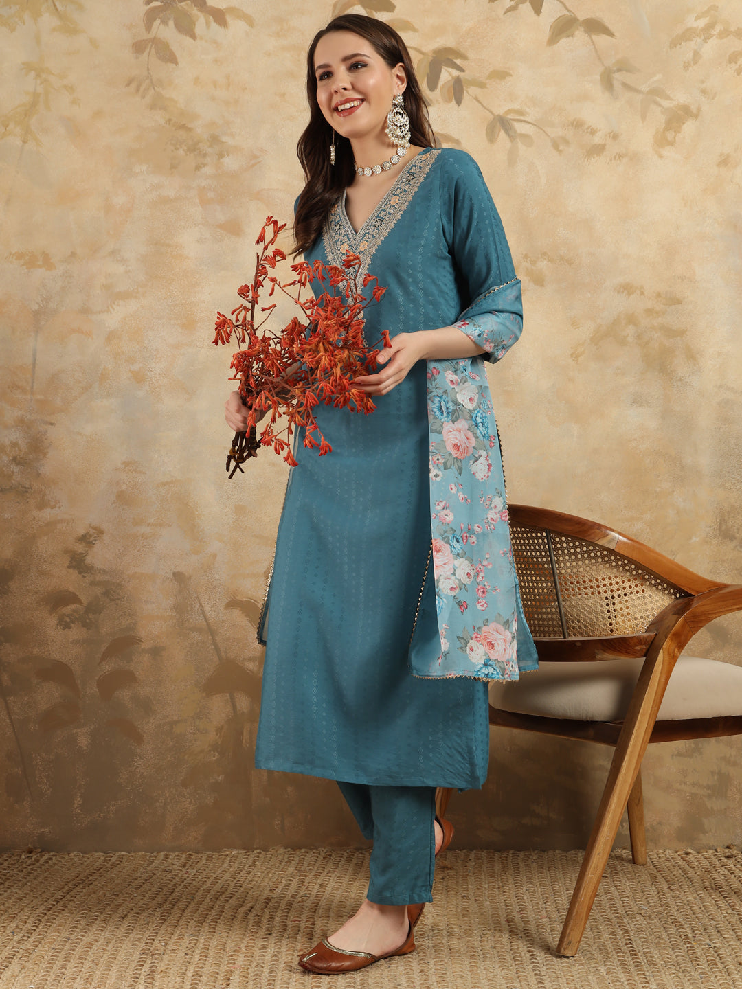 Infuse your wardrobe with elegance in this teal kurta set, showcasing delicate embroidery and a romantic floral dupatta