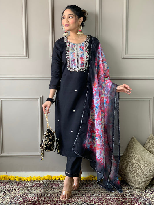 Make a statement with this elegant black kurta set, featuring delicate pearl embellishments and a striking floral dupatta