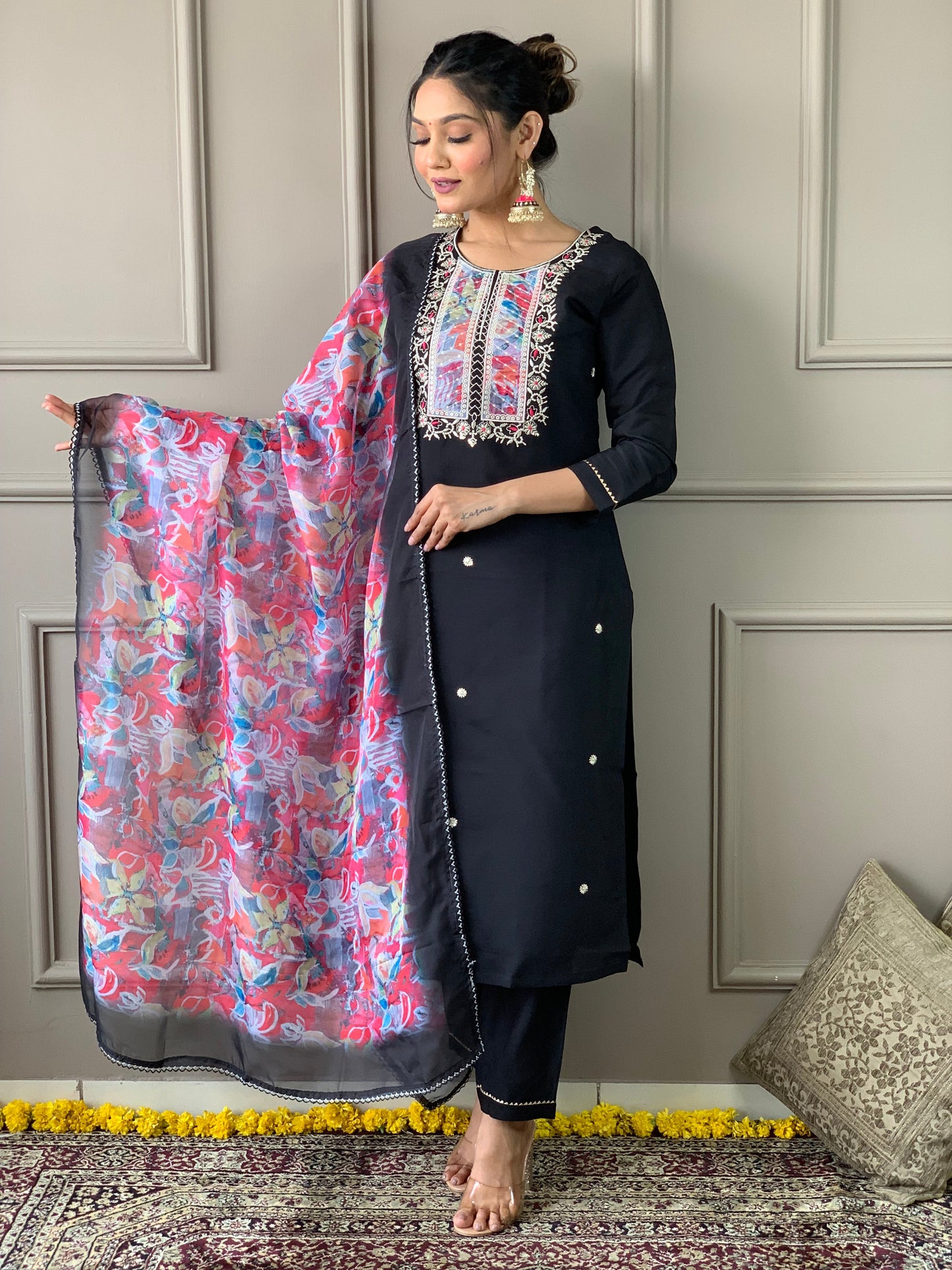 Make a statement with this elegant black kurta set, featuring delicate pearl embellishments and a striking floral dupatta