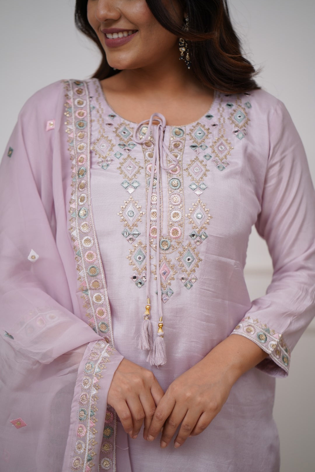 Grace meets elegance in this pastel lavender kurti set, adorned with delicate embroidery and mirror work