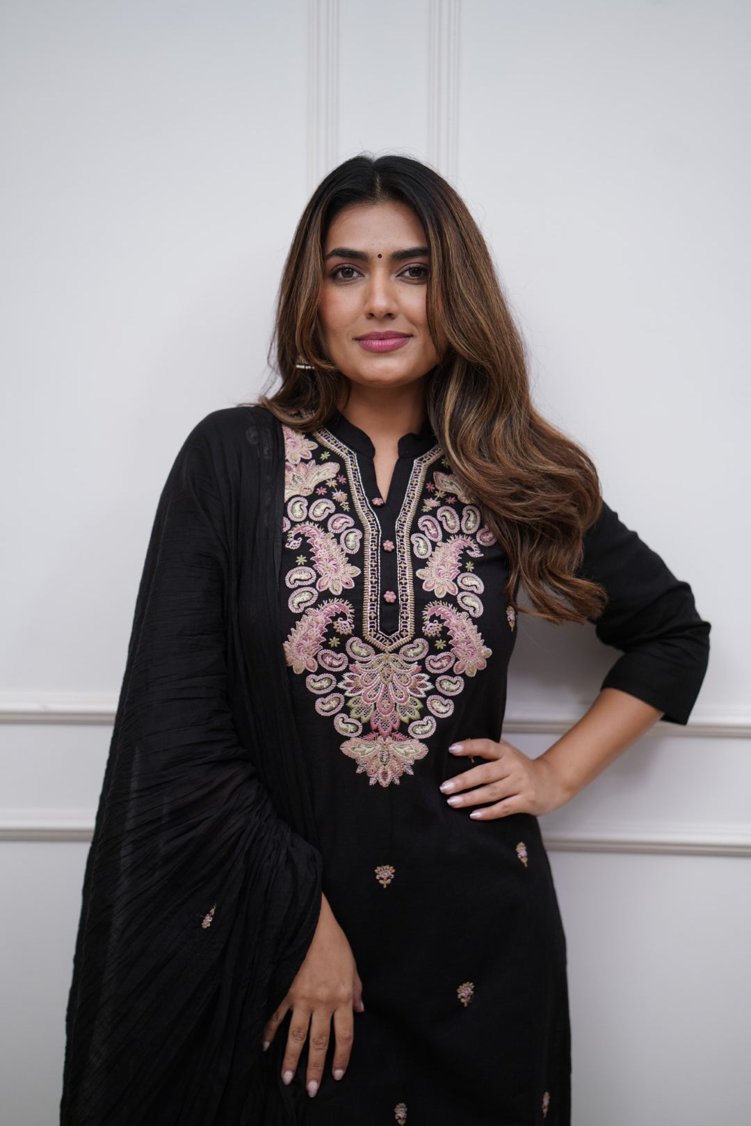 Make a bold statement with this classic black kurti set, featuring intricate pastel embroidery and a matching dupatta