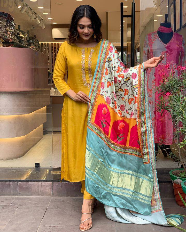 Brighten up your wardrobe with this mustard yellow kurti set, featuring delicate embroidery and a vibrant multicolored dupatta