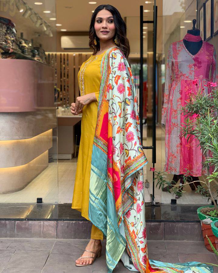 Brighten up your wardrobe with this mustard yellow kurti set, featuring delicate embroidery and a vibrant multicolored dupatta