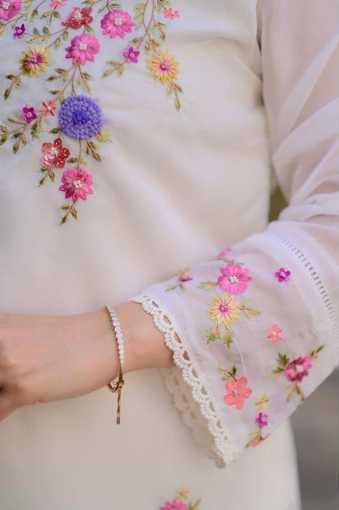 Radiate grace in this white floral embroidered kurti set, featuring delicate pastel blooms and a soft, flowy silhouette