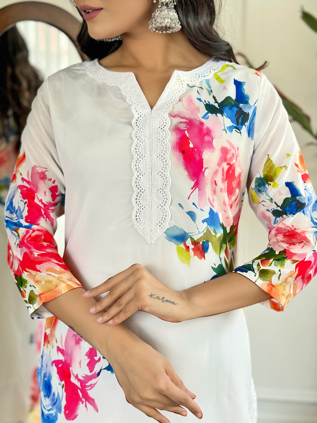Radiate grace in this stunning white floral Kurti set, adorned with vibrant blossoms and a delicate lace neckline
