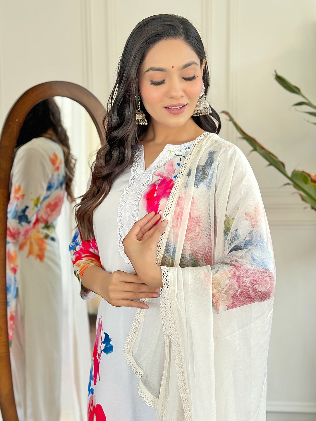 Radiate grace in this stunning white floral Kurti set, adorned with vibrant blossoms and a delicate lace neckline